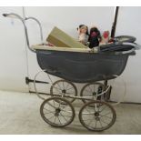 An early/mid 20thC dolls pram, contemporary dolls and accessories