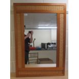 A modern mirror, set in a pine and woven cane frame  28" x 40"