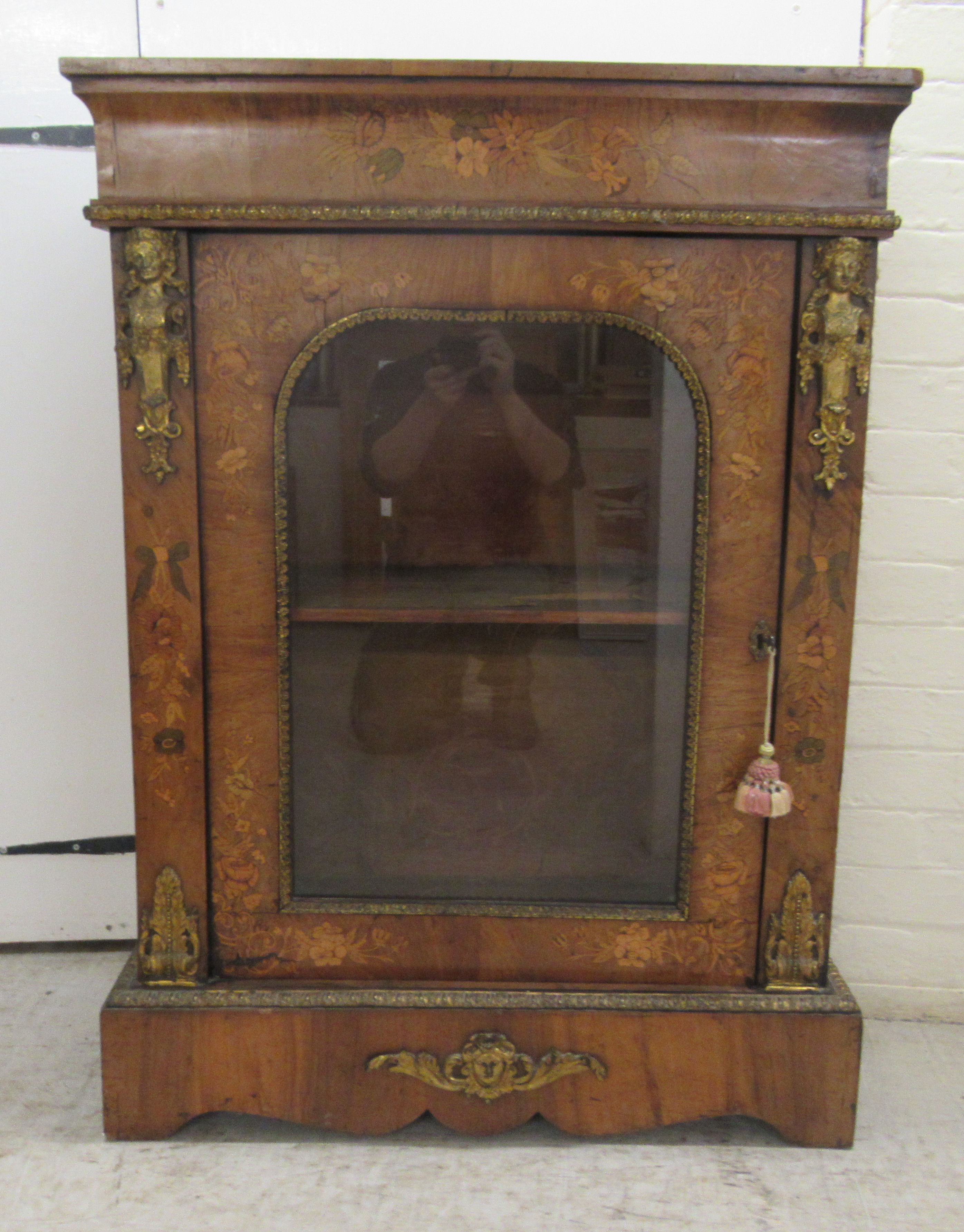 A late 19thC Continental gilt metal mounted walnut and floral marquetry pier cabinet, enclosed by