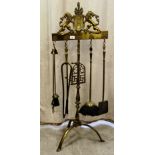 A baronial style brass fireside companion with implements  46"h