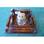 A 1930s oak novelty deskstand, surmounted by an inkwell, the lid fashioned as a cat's face