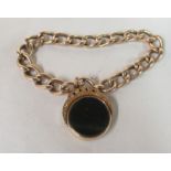 A 9ct gold chain link bracelet with a swivel seal pendant