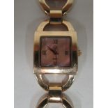 A ladies rose gold plated silver bracelet watch, set with red stones, faced by an Arabic dial