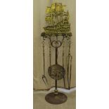 A baronial style brass fireside companion with implements  48"h