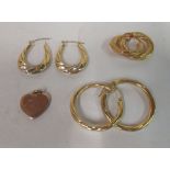 Three pairs of 9ct gold hoop earrings and a 9ct gold heart shaped pendant