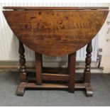 A George III and later oak drop leaf occasional table, raised on turned and block legs, splayed