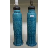 A pair of early 20thC Arts & Crafts inspired Burmantofts Faience table lamps of cylindrical form