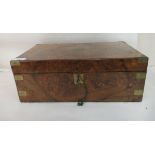 A late 19thC brass bound walnut writing slope with straight sides and a hinged lid, enclosing a part
