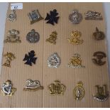 Twenty military cap badges, some copies: to include North Stafford, Inniskilling and The Queen's Own