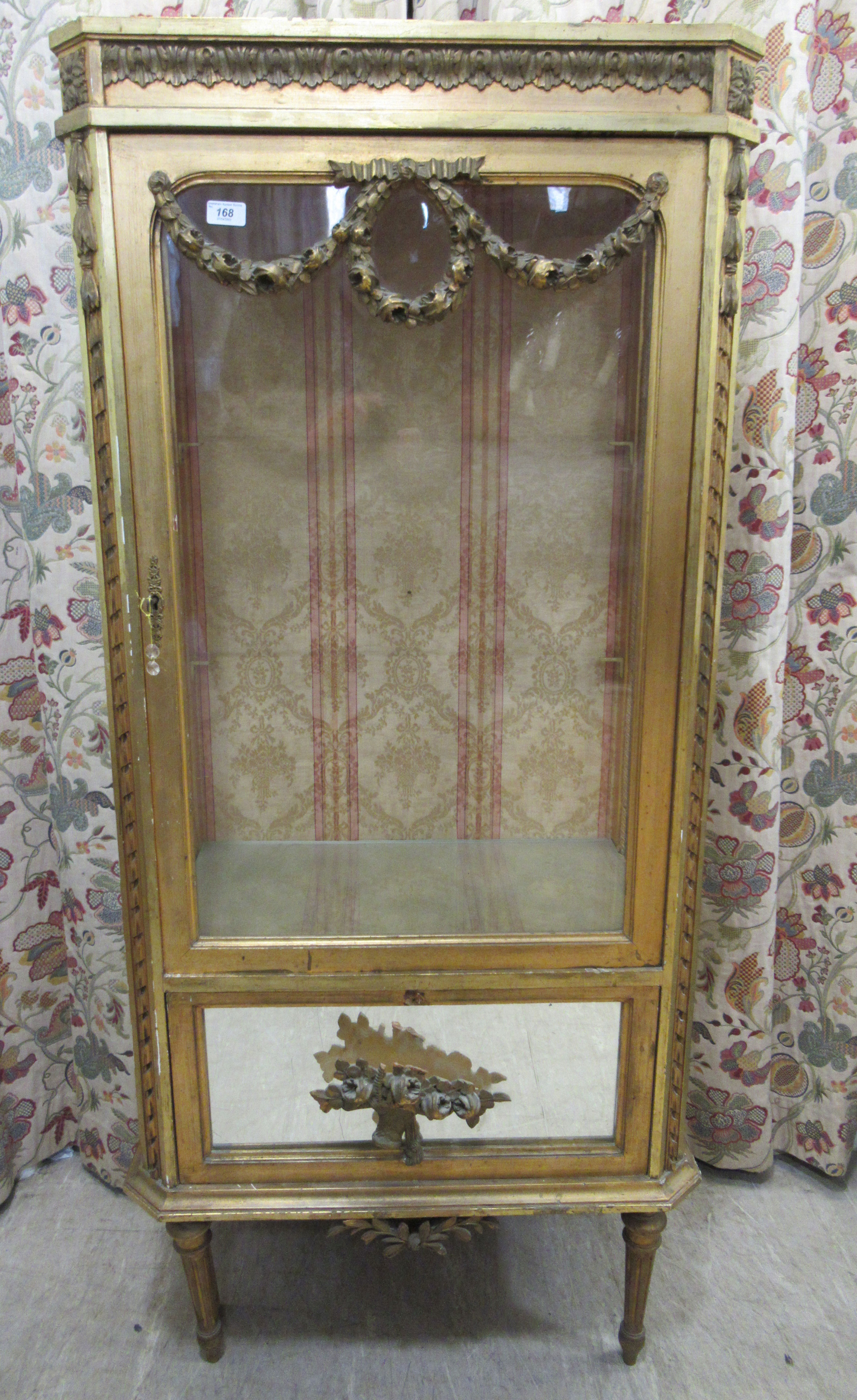 A late 19thC fully glazed giltwood and glass display cabinet with a single glazed door, surmounted