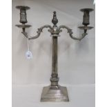 A 20thC silver plated on copper twin branch candelabrum, on a pillar capital and stepped square