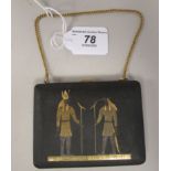 A Middle Eastern yellow metal and matt black enamel folding combination cigarette case and powder