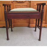 A 1920s mahogany framed and upholstered box top piano stool with level arms on spindles and turned