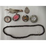 Items of personal ornament: to include a Celtic design brooch and a birds claw glad mounted brooch