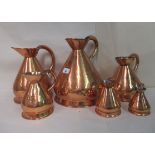 A graduated set of six early 20thC copper jugs  largest one gallon