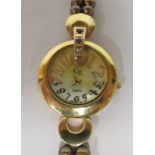 A ladies gold plated silver bracelet watch, set with pearls, faced by an Arabic dial