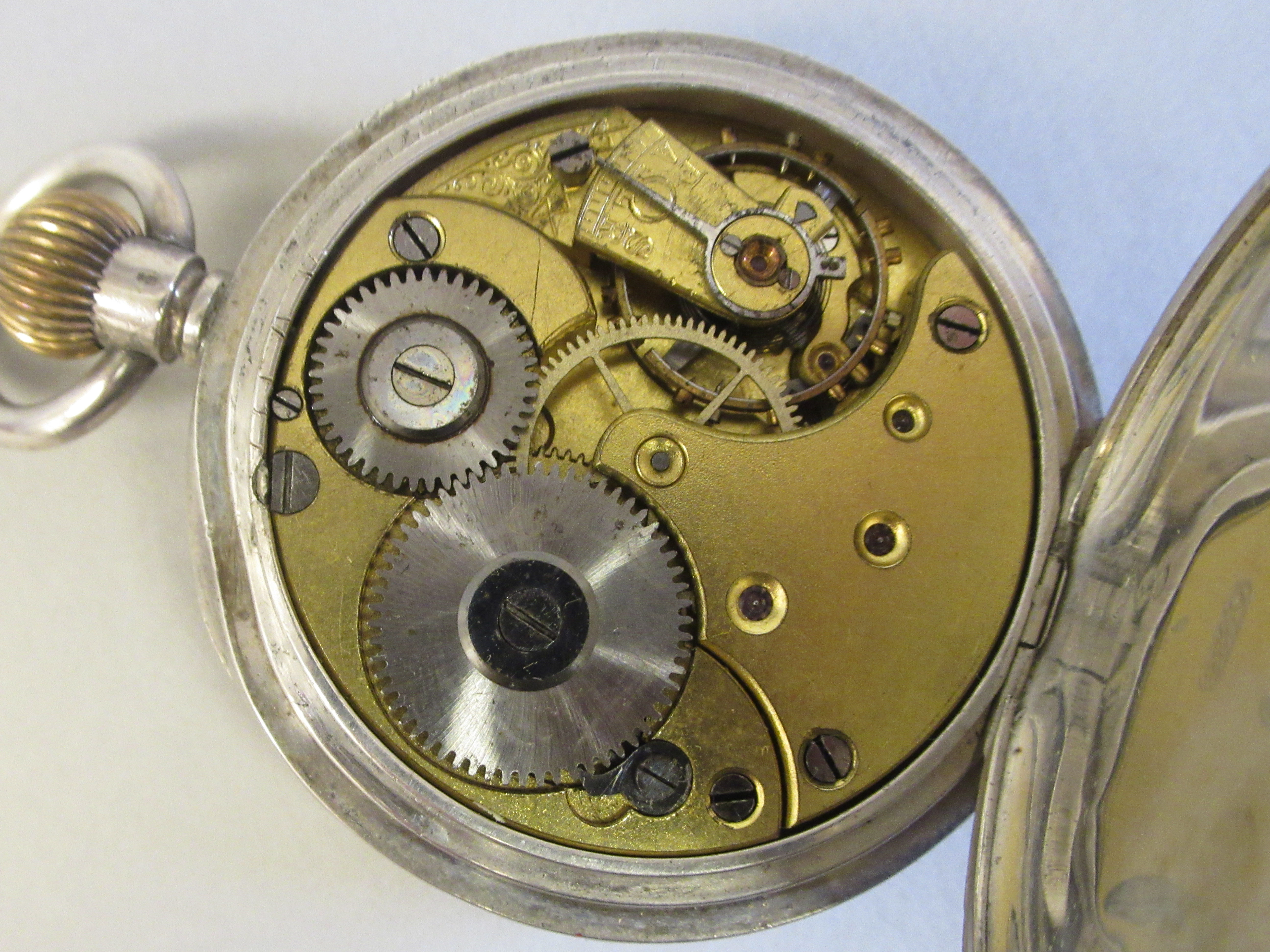 An Omega (935) silver coloured metal cased pocket watch with an engine turned back, faced by a white - Image 3 of 4