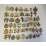 Approx. fifty military cap badges and other insignia, some copies: to include York and Lancaster;