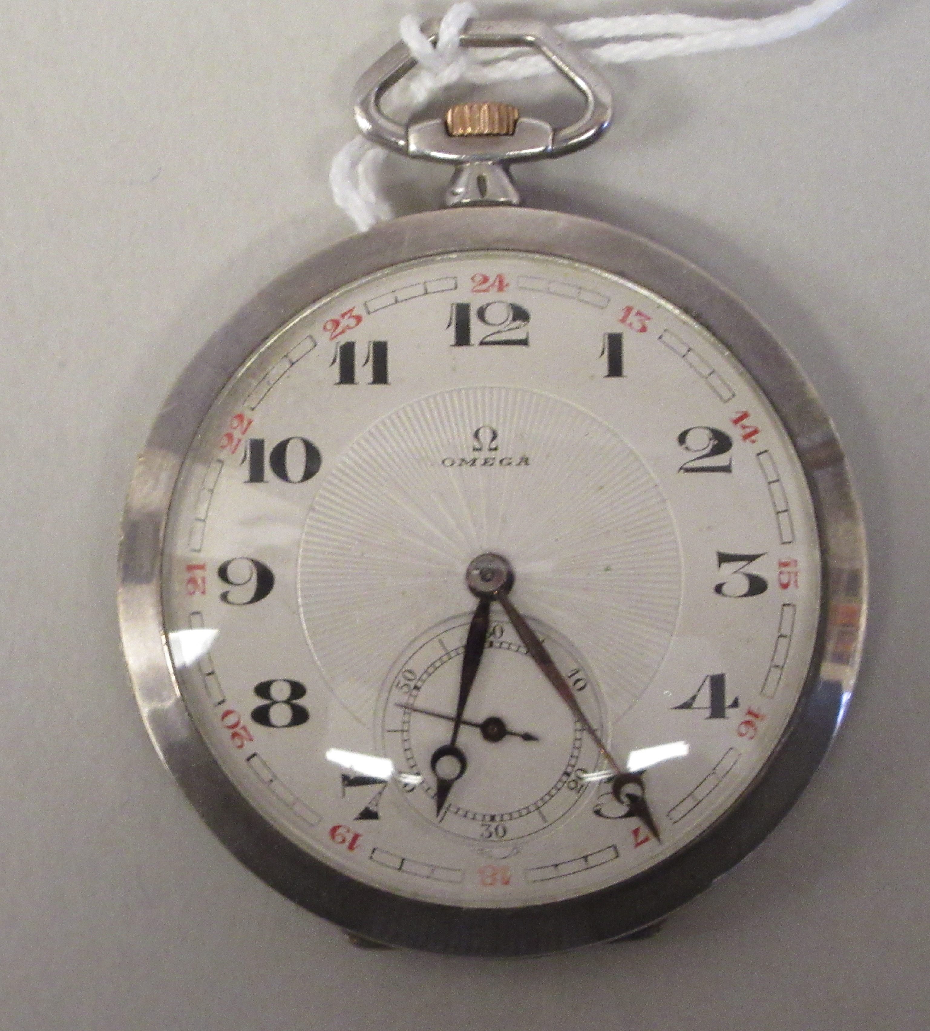 An Omega (900) silver coloured metal, slim cased pocket watch with a radiating engraved back,