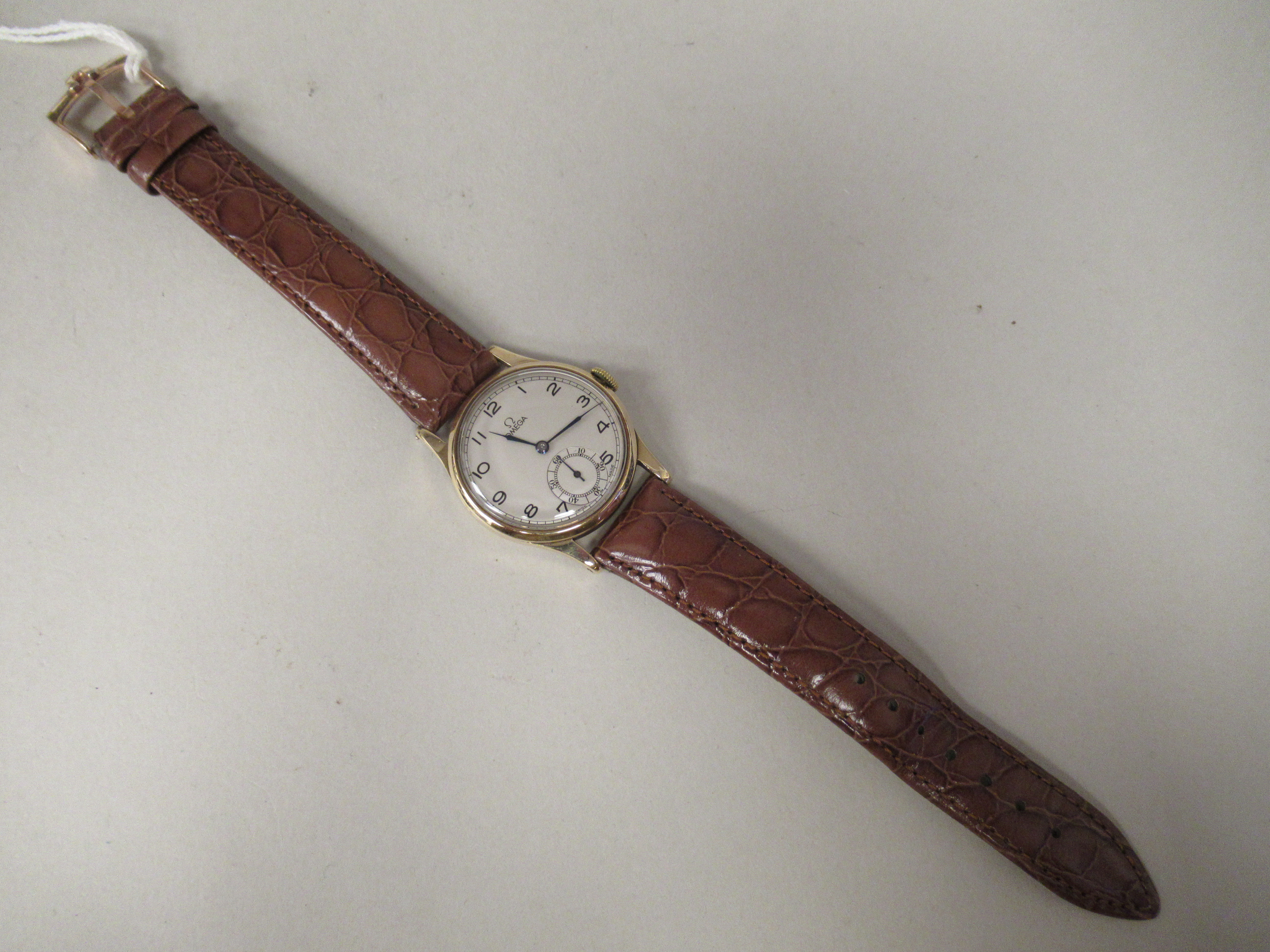 A 1957 Omega 9ct gold cased wristwatch, faced by a silvered Arabic dial, incorporating a subsidiary, - Image 2 of 3