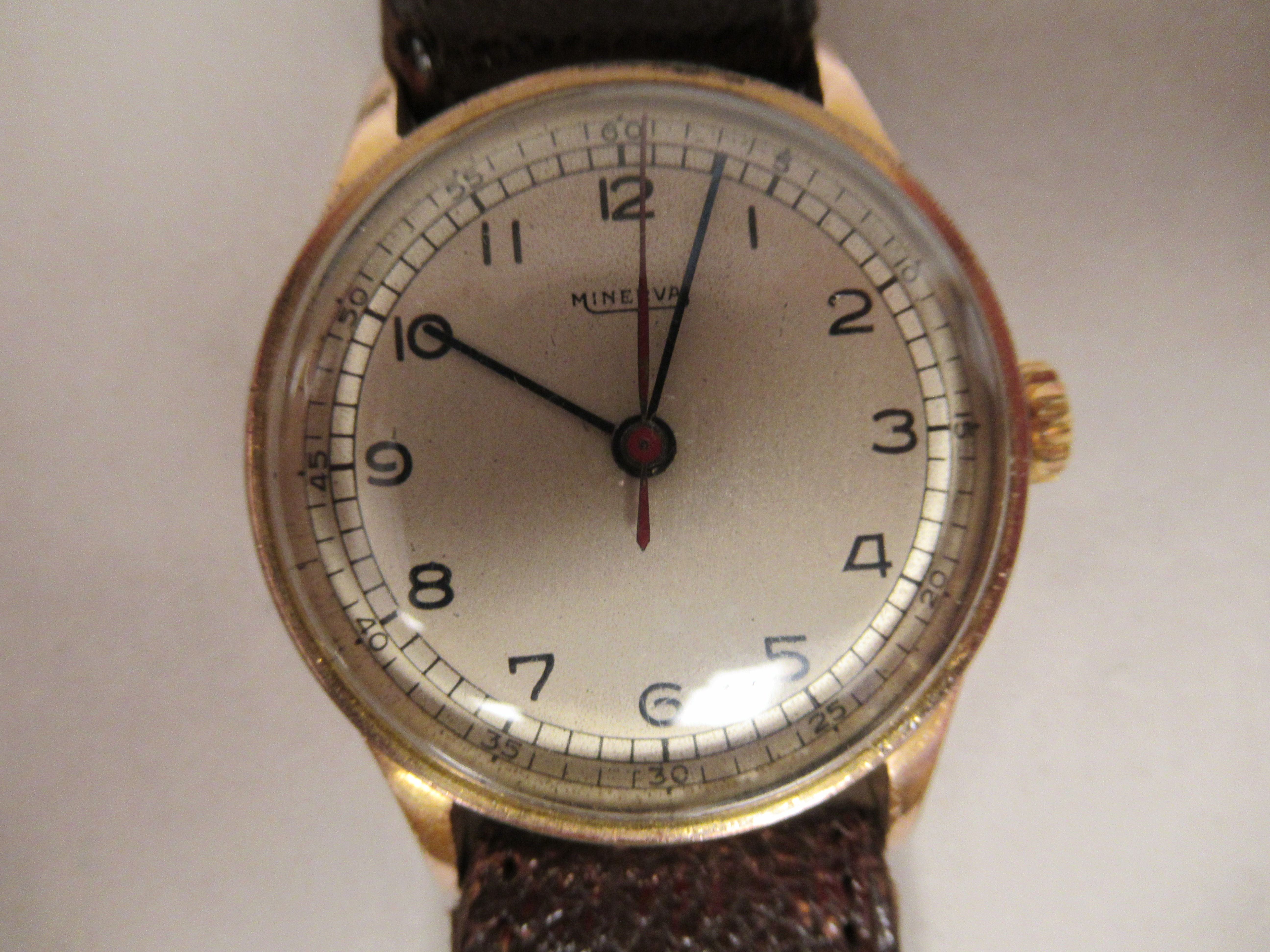 A 1940/50s Minerva gold plated/stainless steel cased wristwatch, faced by a silvered Arabic dial, on