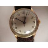 A 1940/50s Minerva gold plated/stainless steel cased wristwatch, faced by a silvered Arabic dial, on