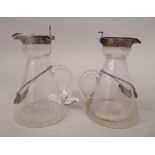 A pair of Edwardian glass whisky tots of conical form, each with a star cut base, applied silver