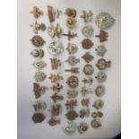 Approx. fifty military cap badges and other insignia, some copies: to include The Royal Guernsey;
