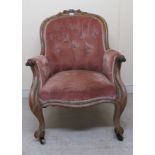 A mid Victorian mahogany showwood framed, spoonback grandfather chair with enclosed arms and