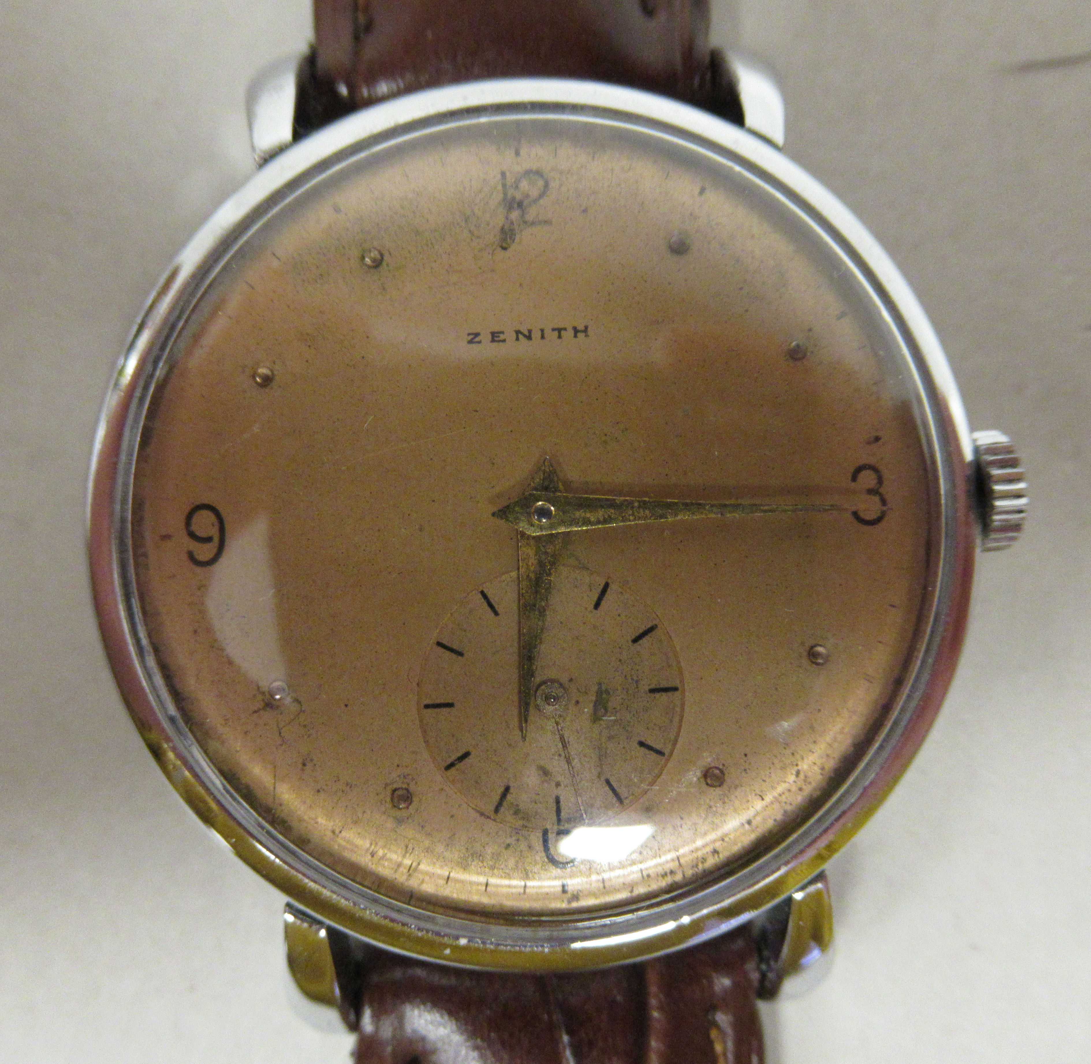 A 1940s Zenith stainless steel cased wristwatch, faced by a bronze effect Arabic and baton dial,