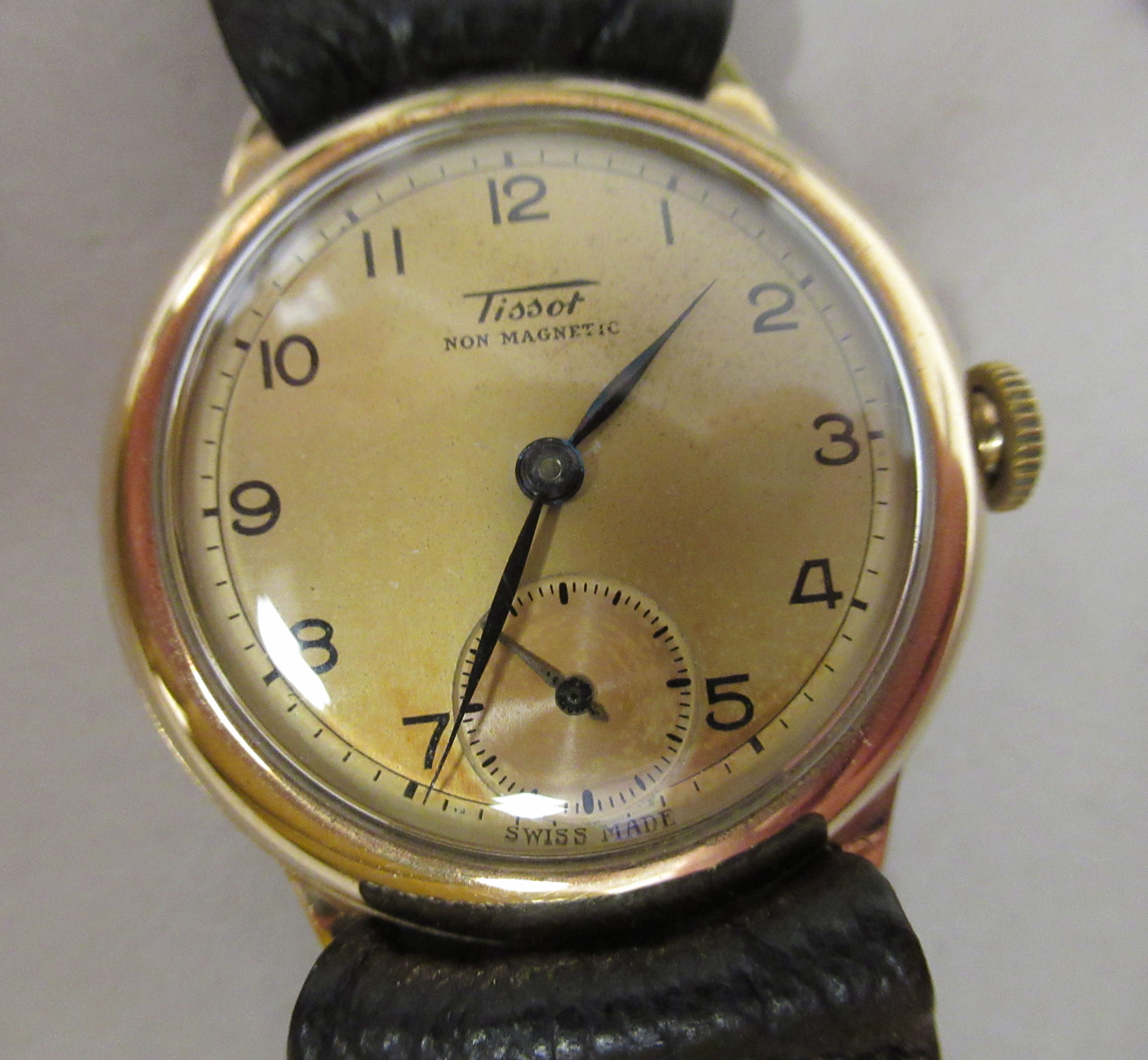 A 1930/40s Tissot 9ct gold cased wristwatch, faced by a bronze effect Arabic dial, incorporating a