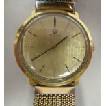 An early 1970s Omega gold plated/stainless steel cased wristwatch, faced by a gilded baton dial,