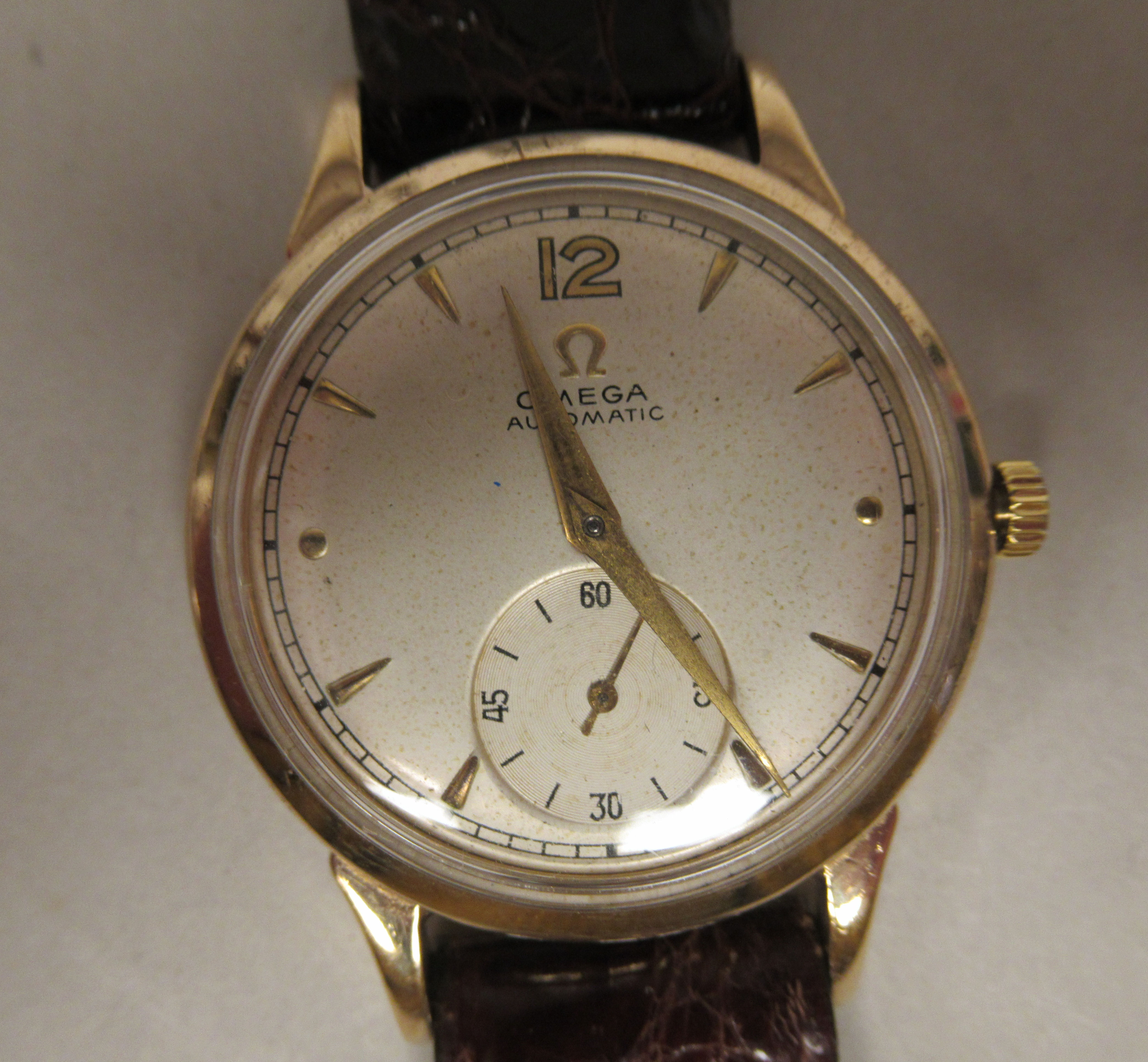 A 1950s Omega 9ct gold cased wristwatch, faced by a baton dial, incorporating a subsidiary, on a