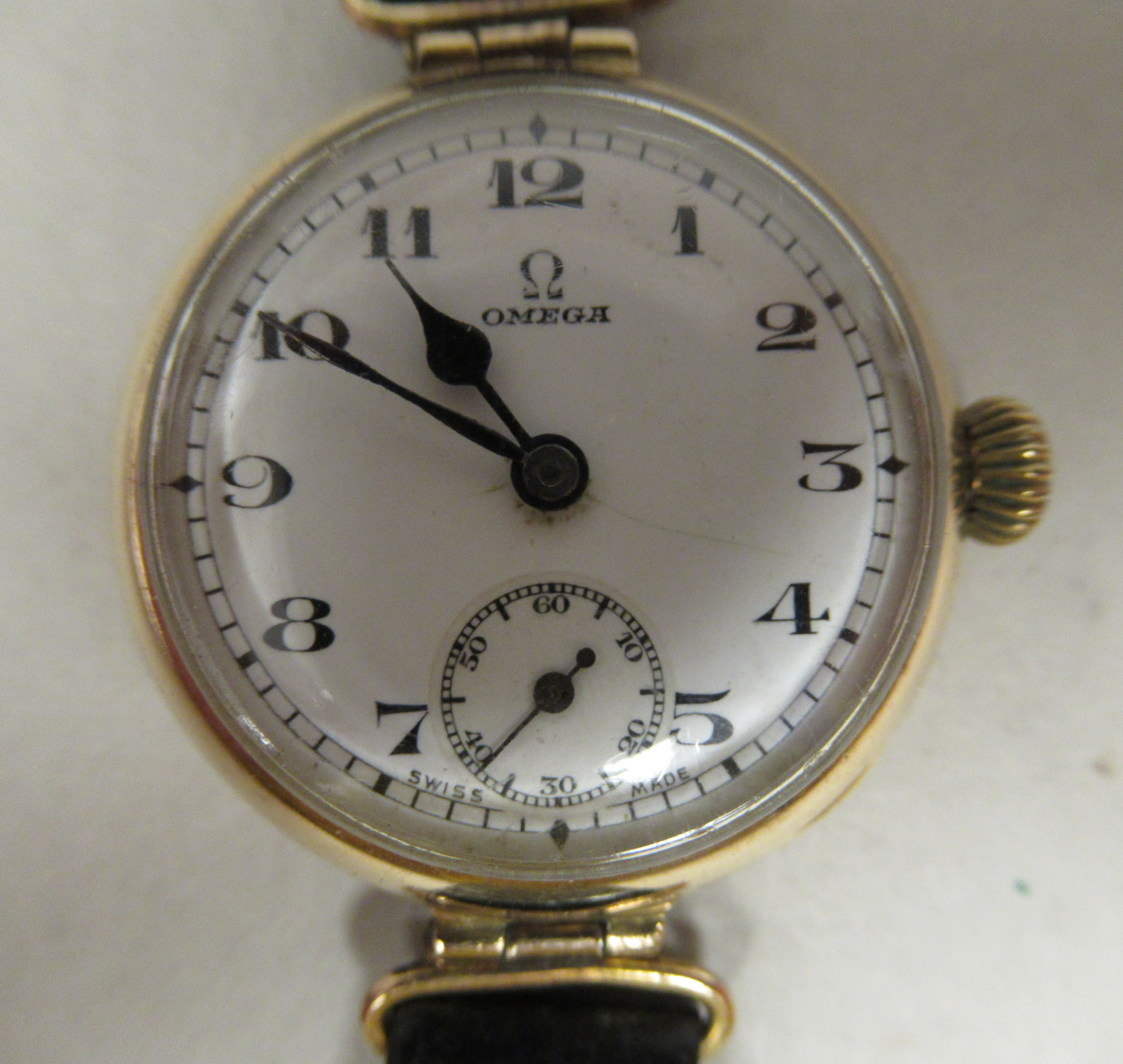 A 1920/30s lady's Omega 9ct gold cased wristwatch, faced by a white enamel Arabic dial,