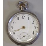 An Omega (935) silver coloured metal cased pocket watch with an engine turned back, faced by a white