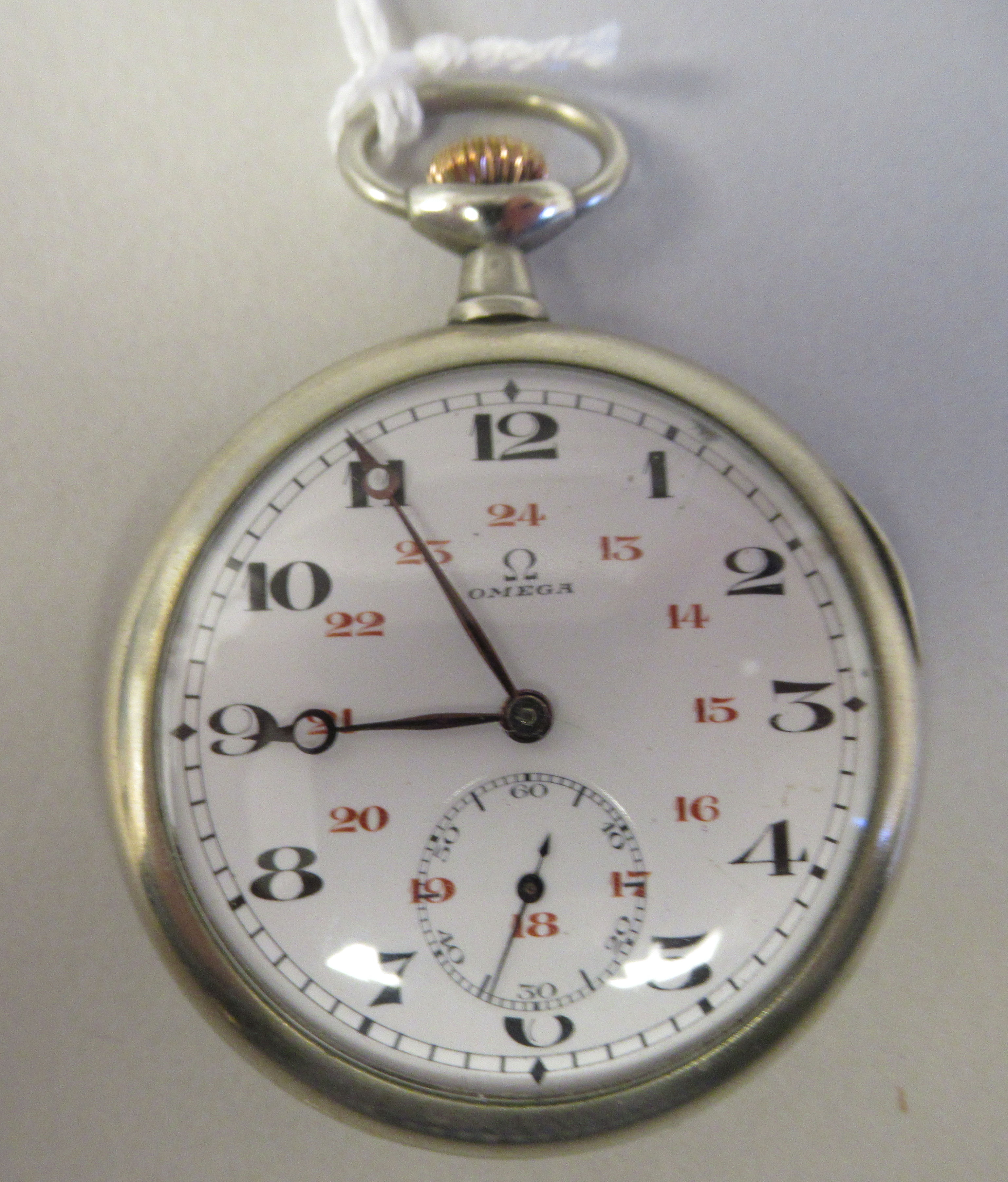 An Omega stainless steel cased, 24 hour pocket watch, faced by a white enamel Arabic dial,