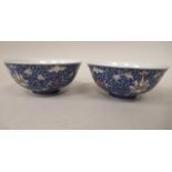 A pair of Chinese Republic porcelain footed bowls, painted with foliage, on a blue ground  5"dia