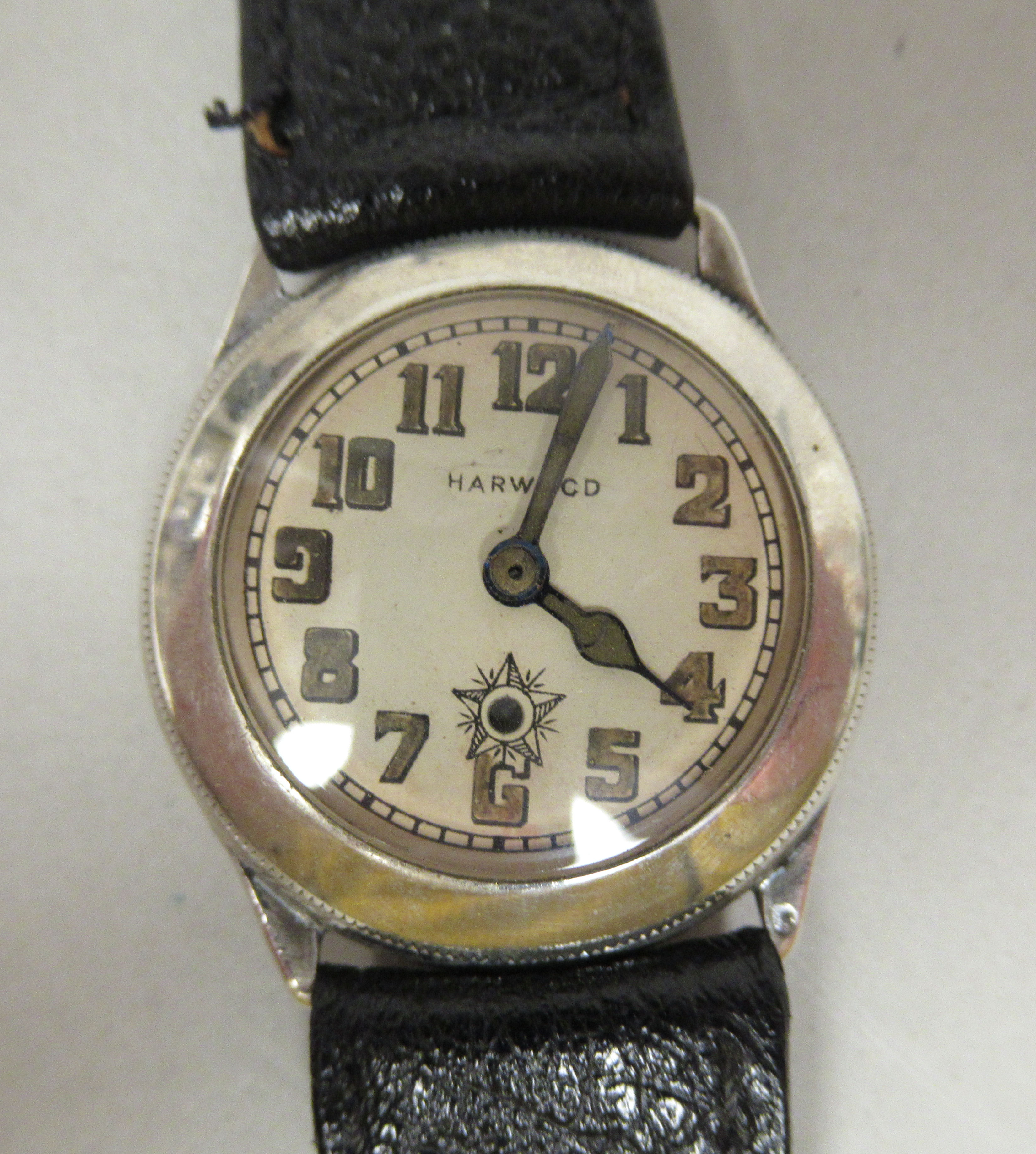 A 1929 Harwood silver cased wristwatch, (the first) automatic movement faced by an Arabic dial, on a