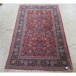 A Persian rug decorated with floral designs on a multi-coloured ground  53" x 83"