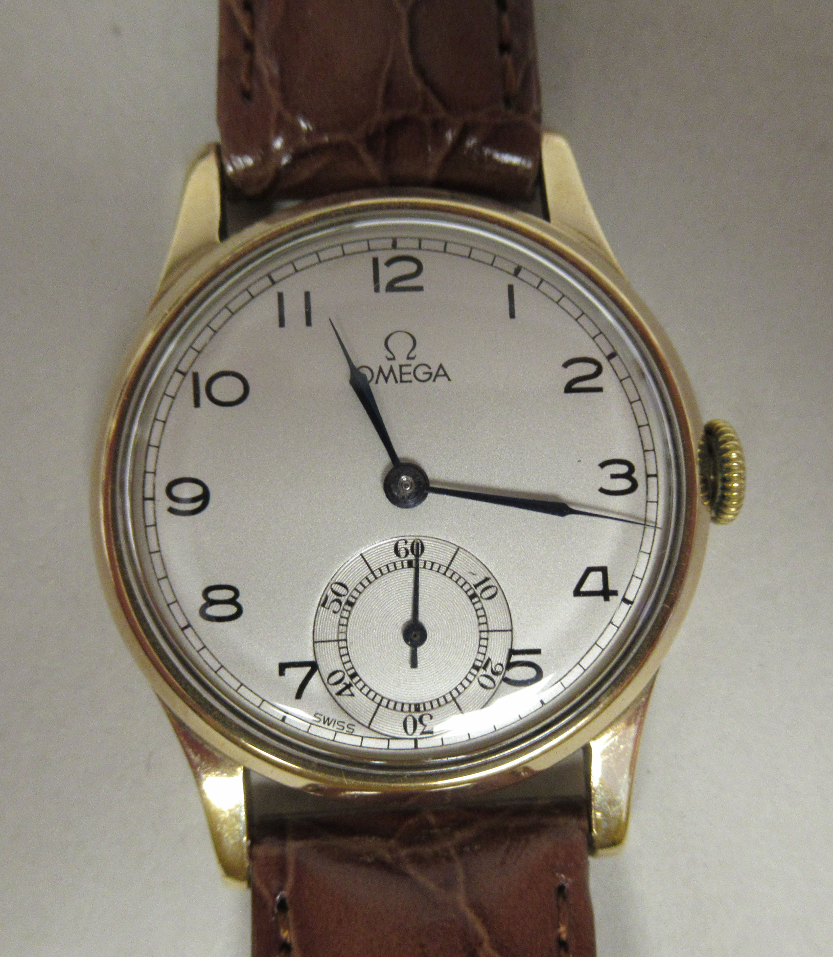 A 1957 Omega 9ct gold cased wristwatch, faced by a silvered Arabic dial, incorporating a subsidiary,