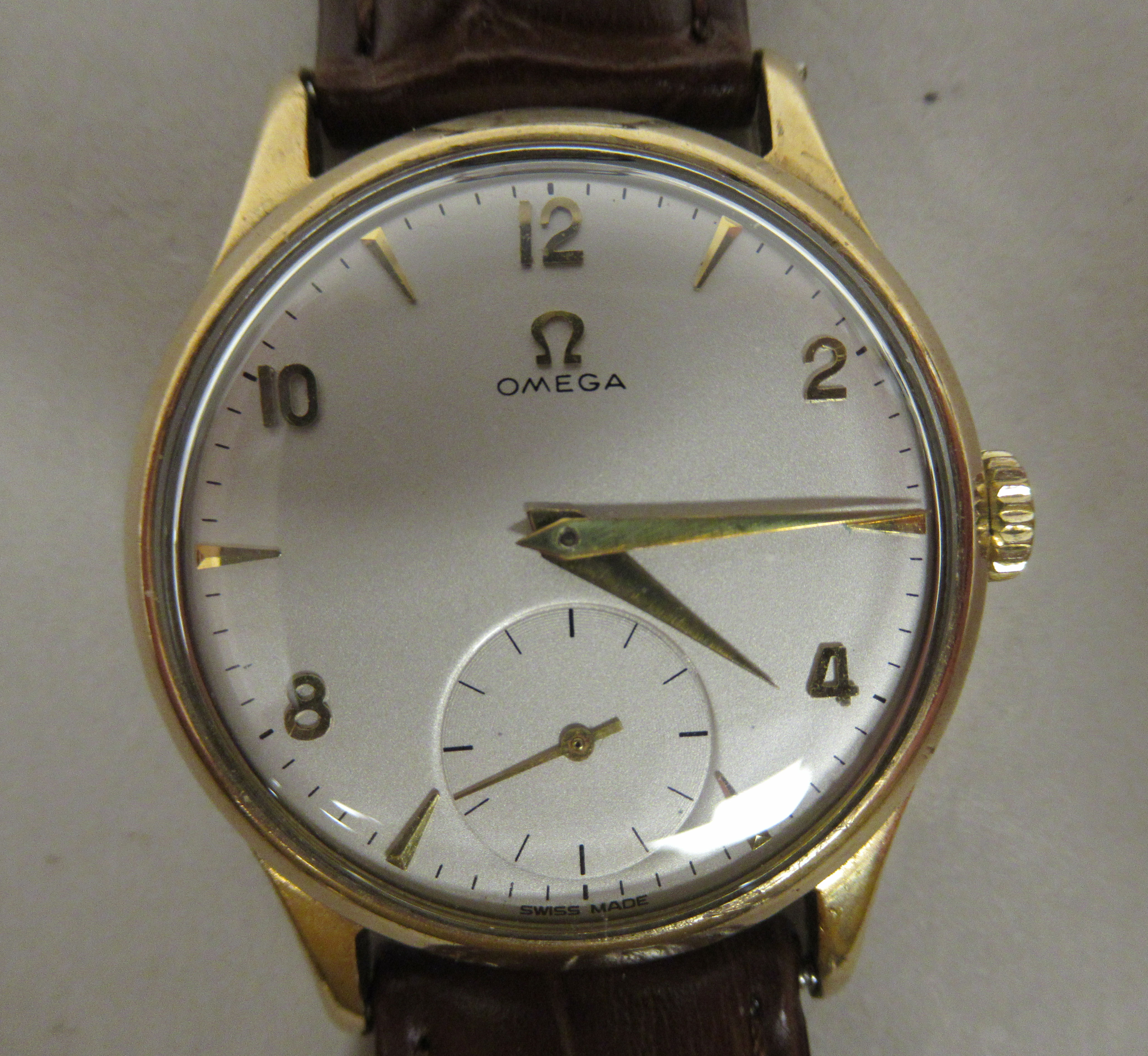 A 1950s Omega 'Big Bumper' 9ct gold cased wristwatch, faced by an Arabic and baton dial,