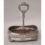 A George IV semi-reeded silver condiments stand of oval form with a gadrooned border and wooden