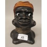 An early 20thC novelty carved wooden blackamoor bust trinket box, the hinged turban revealing a