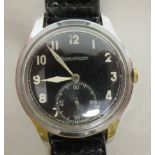 A 1940s Jaeger-LeCoultre military style stainless steel cased wristwatch, faced by a black Arabic