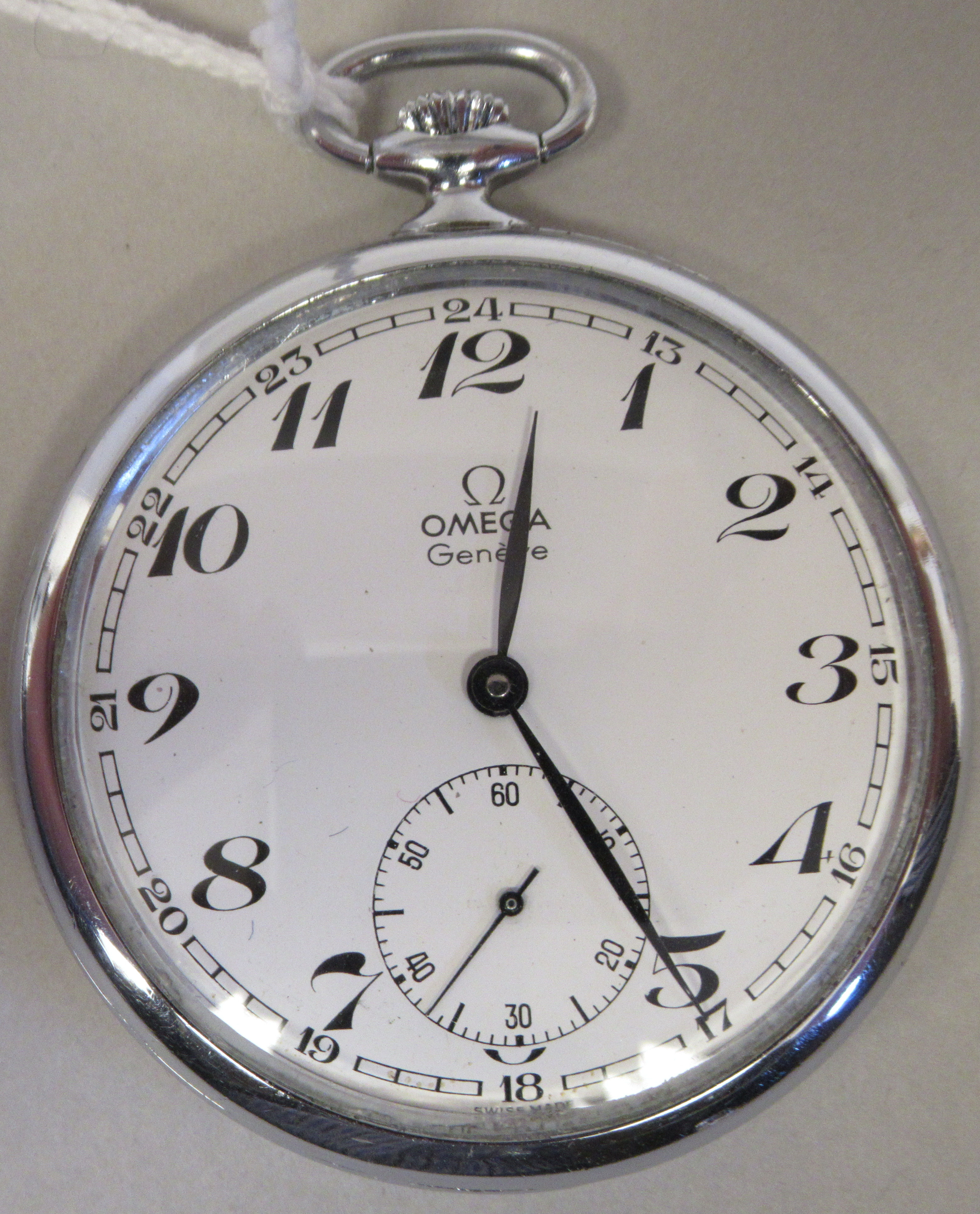 An Omega stainless steel slim cased pocket watch, faced by a white enamel Arabic dial, incorporating
