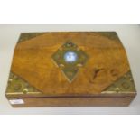 A late Victorian figured oak writing box with applied, decoratively cut and riveted brass mounts,