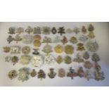 Approx. fifty military cap badges and other insignia, some copies: to include West Yorkshire; West