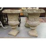 A pair of composition stone pedestal urns, on a square plinth  20"h  15"dia