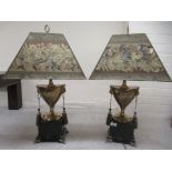A pair of modern cast metal table lamps, fashioned as pedestal urns with opposing lion mask ring