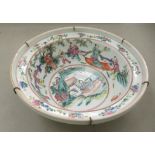 A 19thC Chinese porcelain bowl, having an upstand rim, decorated in recreational figures, bat motifs